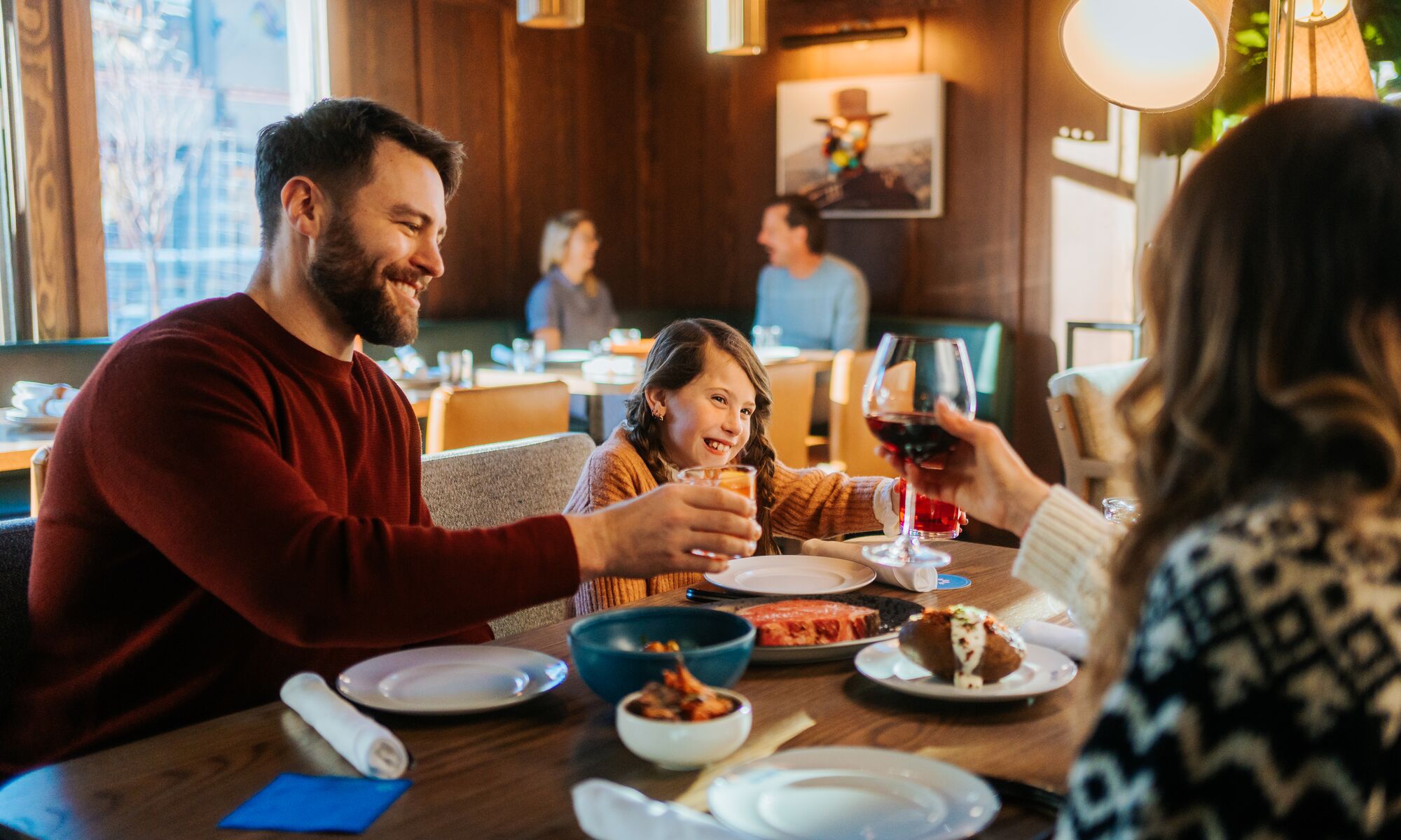 A family eats dinner inside Bluebird in Banff.