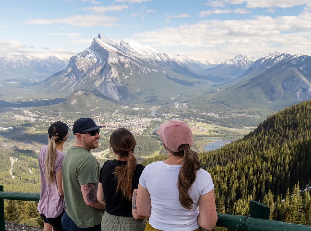 Four people at the Norquay sightseeing chairlift viewpoint, a popular spot in Banff National Park in August