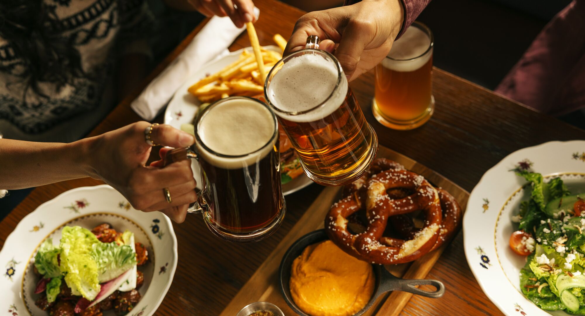 Guests cheersing drinks at Waldhaus Restaurant, Fairmont Banff Springs.