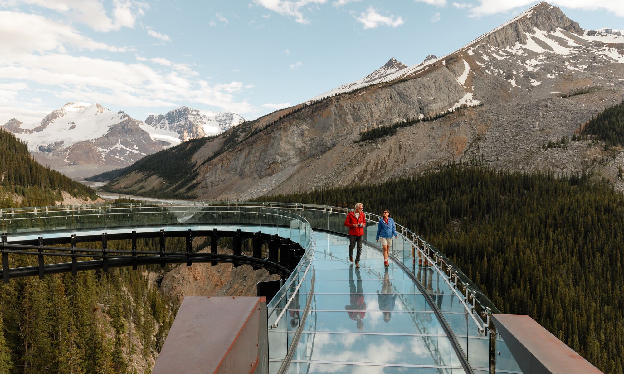The couple is enjoying the perfect mountain view of Columbia Icefield Skywalk.