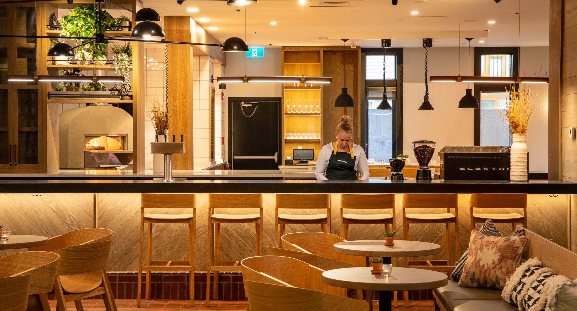 A bartender is working at Farm & Fire located in Banff National Park