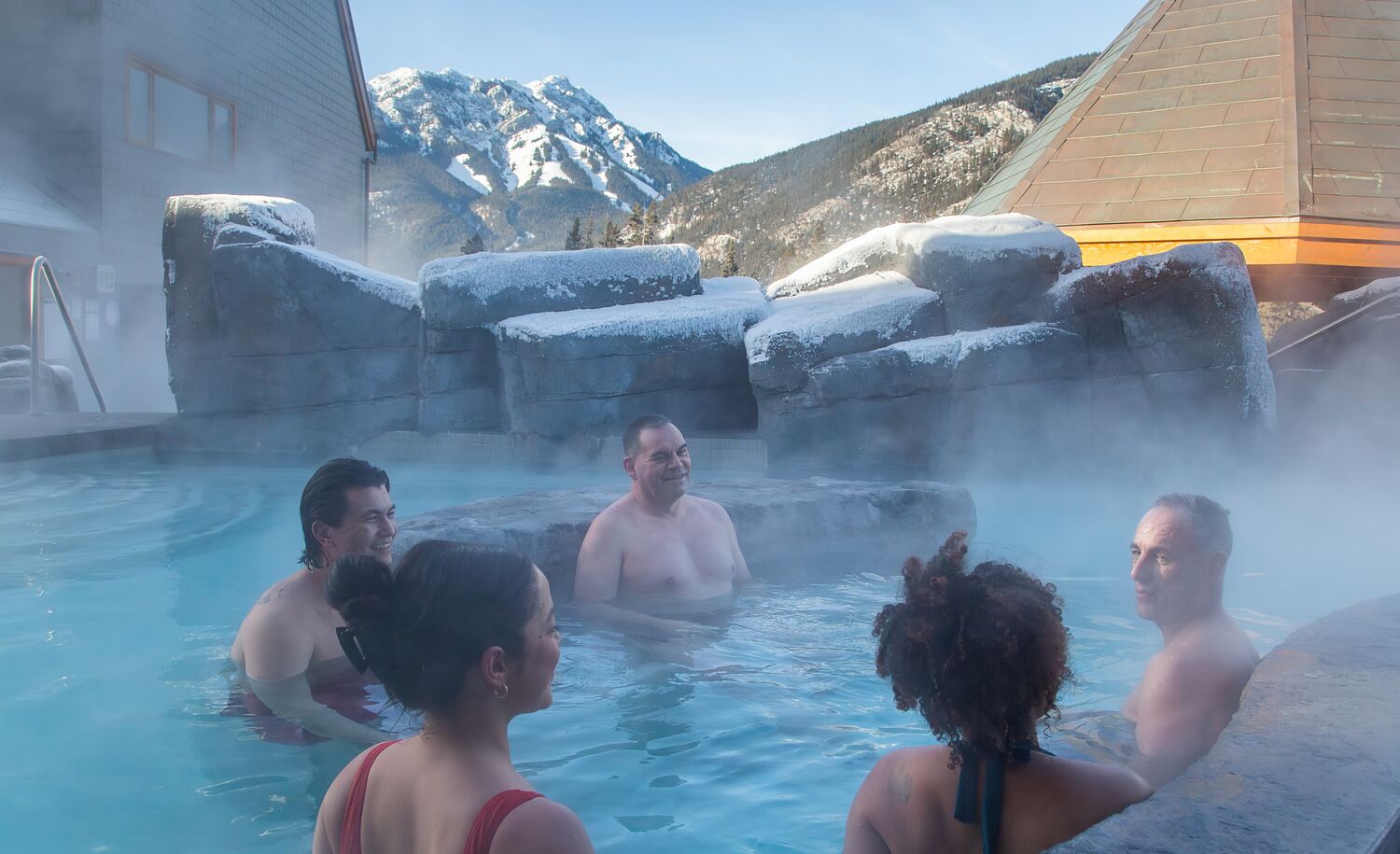 People enjoying the hot tub at Hotel Canoe & Suites in Banff in the winter.