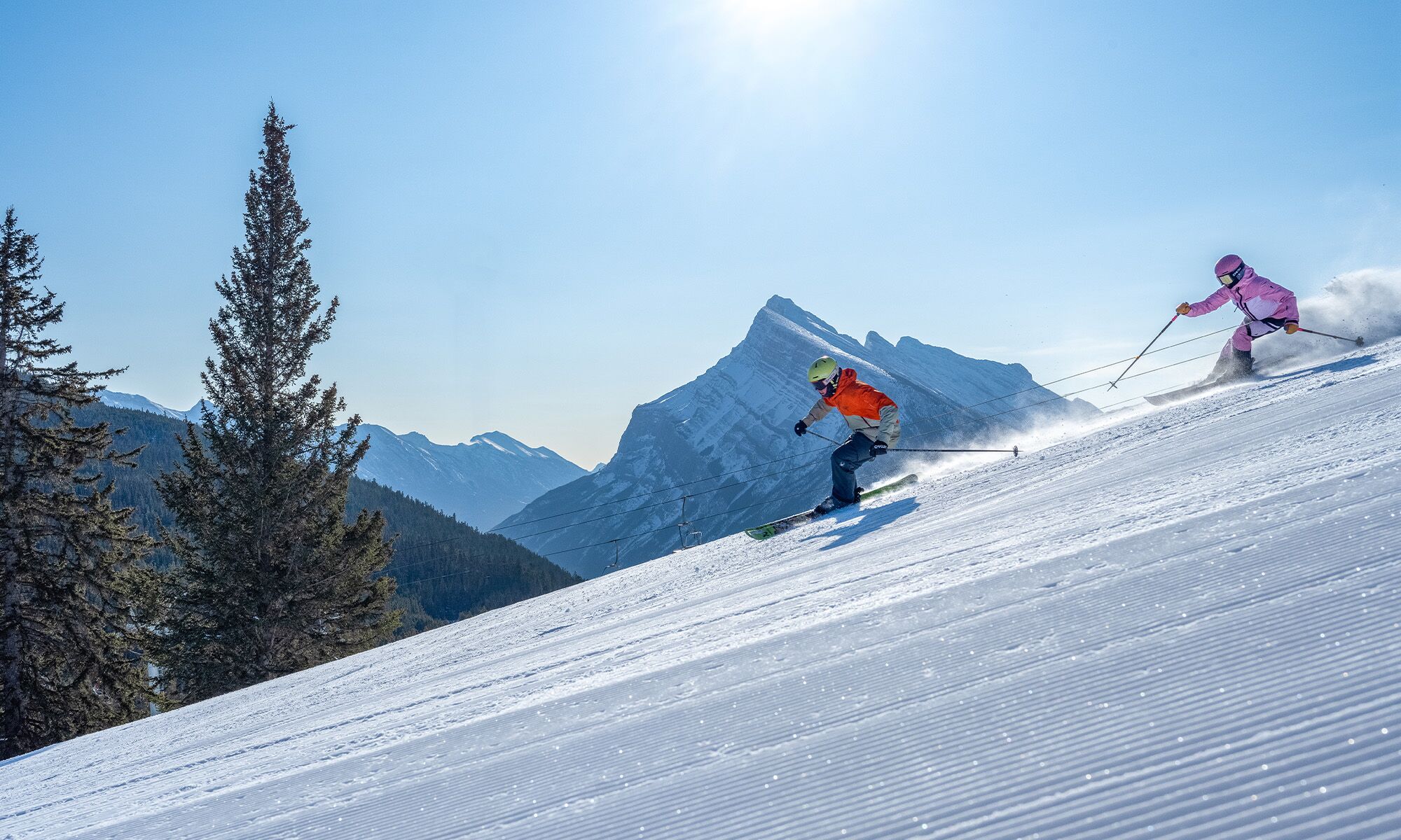 Two people skiing down a run at Mount Norquay in Banff National Park