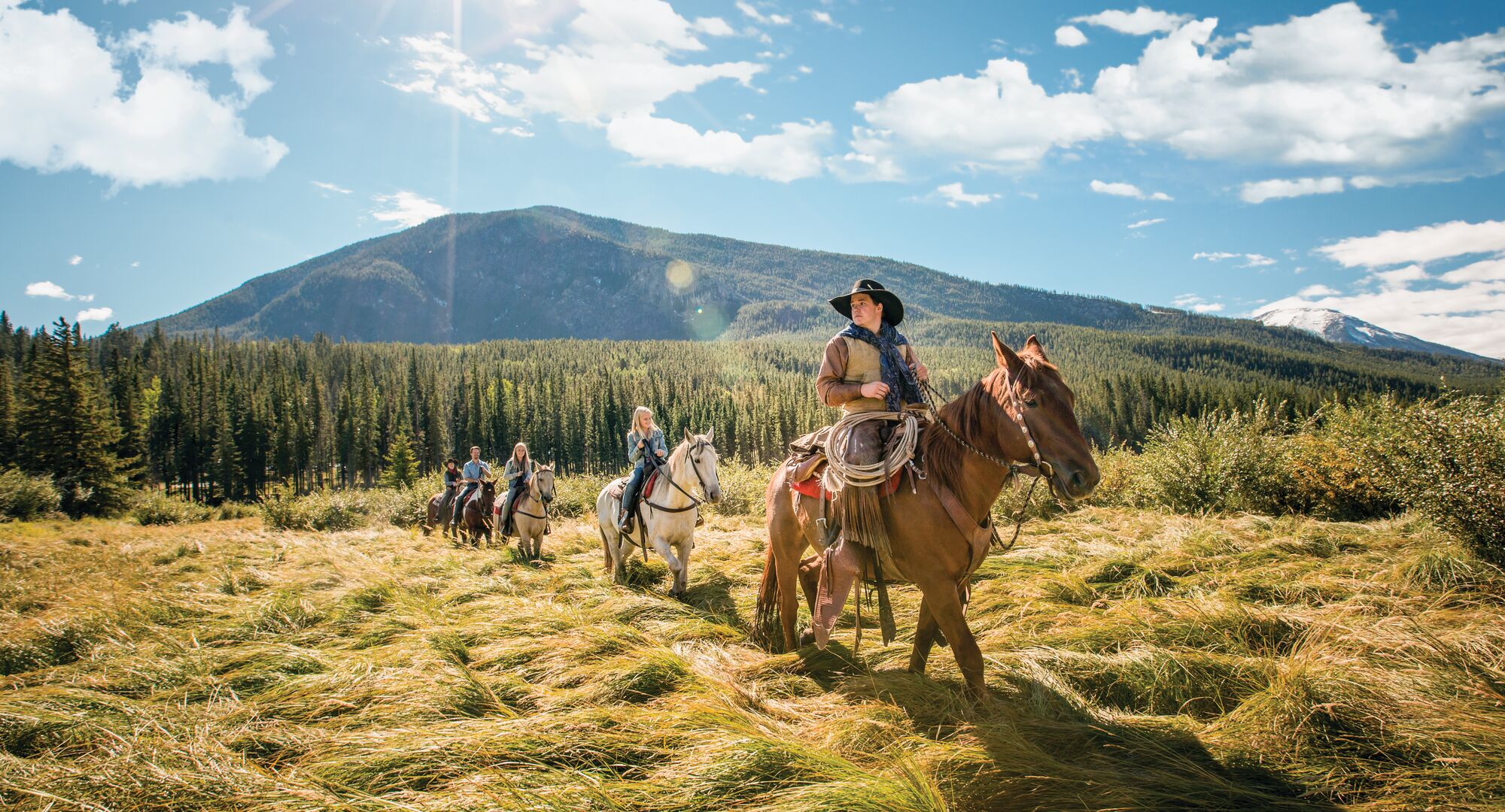 People on horses exploring on a horseback riding tour in Banff National Park