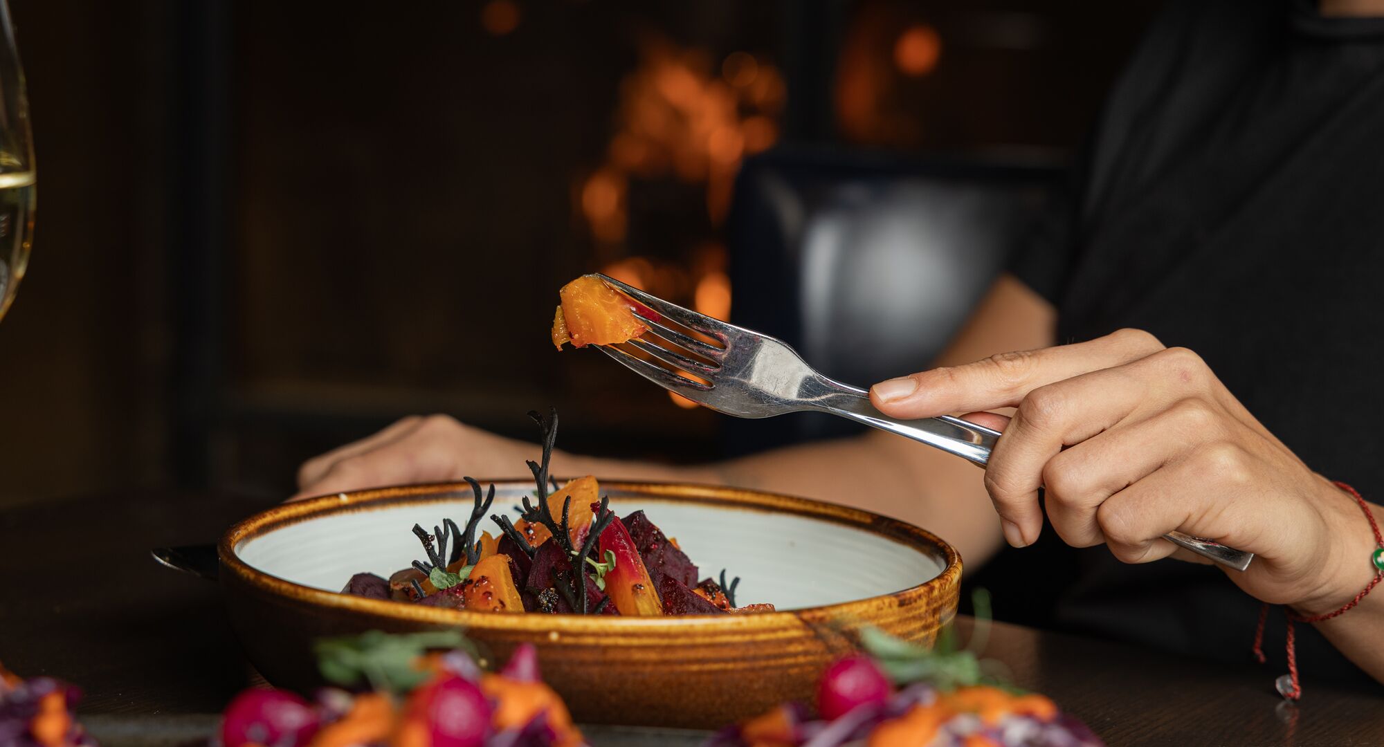 Cosy dining by the fire as a guest enjoys the beatroot medley