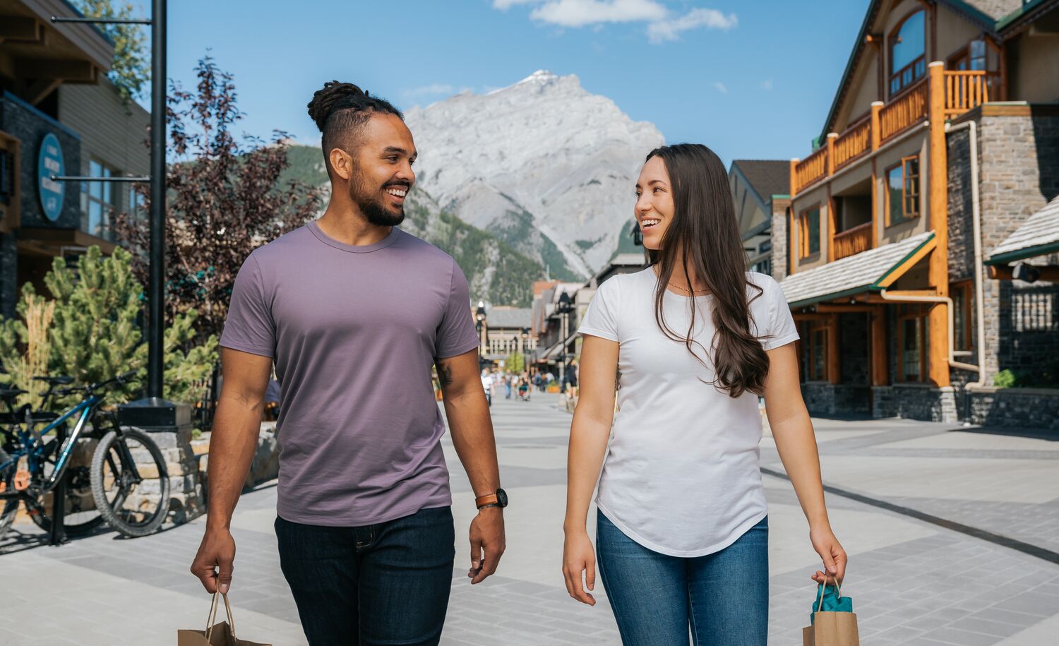 Two people walk on Bear Street while shopping in the Banff Townsite.