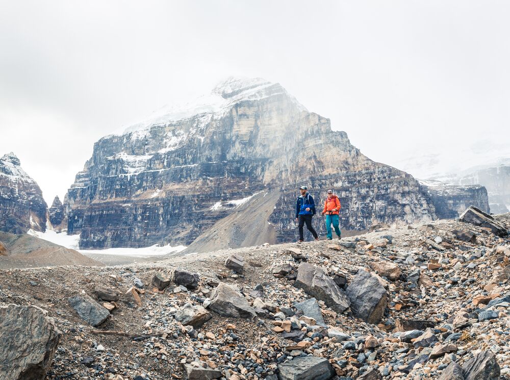 Two people hiking along the Plain of Six Glaciers Teahouse trail in Banff National Park