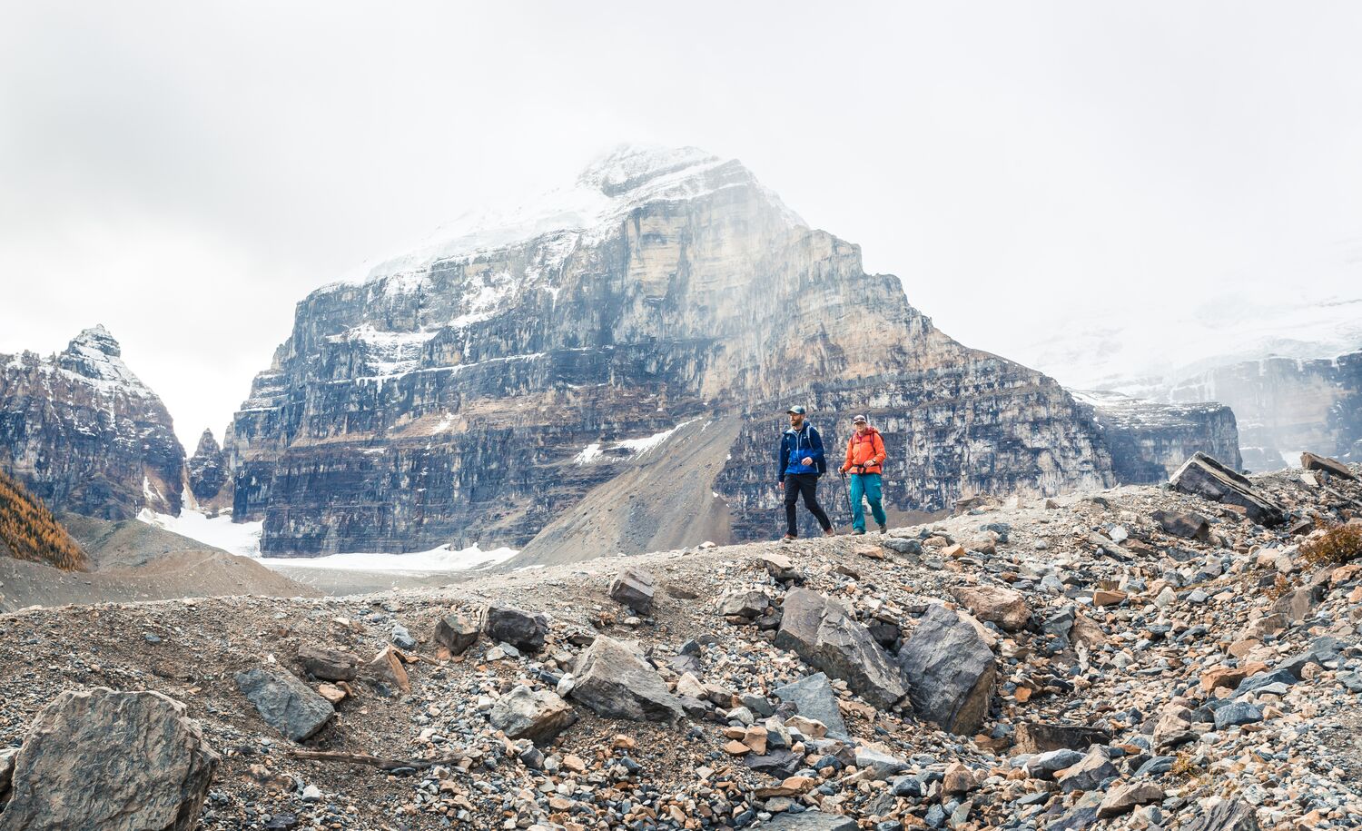 Two people hiking along the Plain of Six Glaciers Teahouse trail in Banff National Park