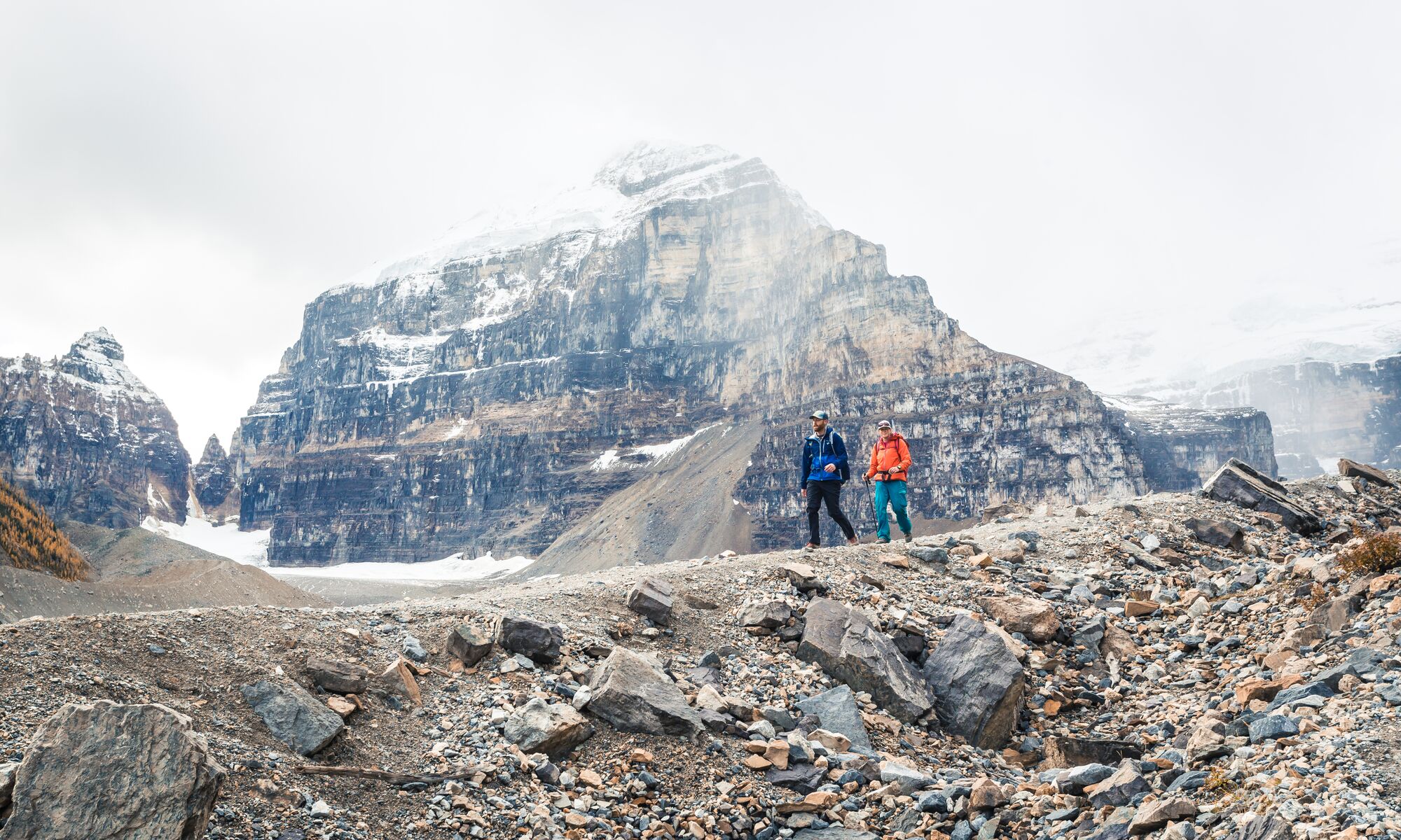 Two people hiking along the Plain of Six Glaciers Teahouse trail in Banff National Park