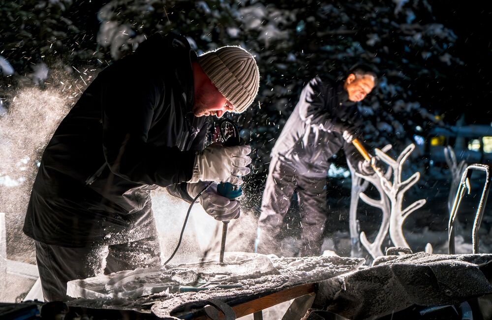 Two professional ice carvers during SnowDays in Banff and Lake Louise