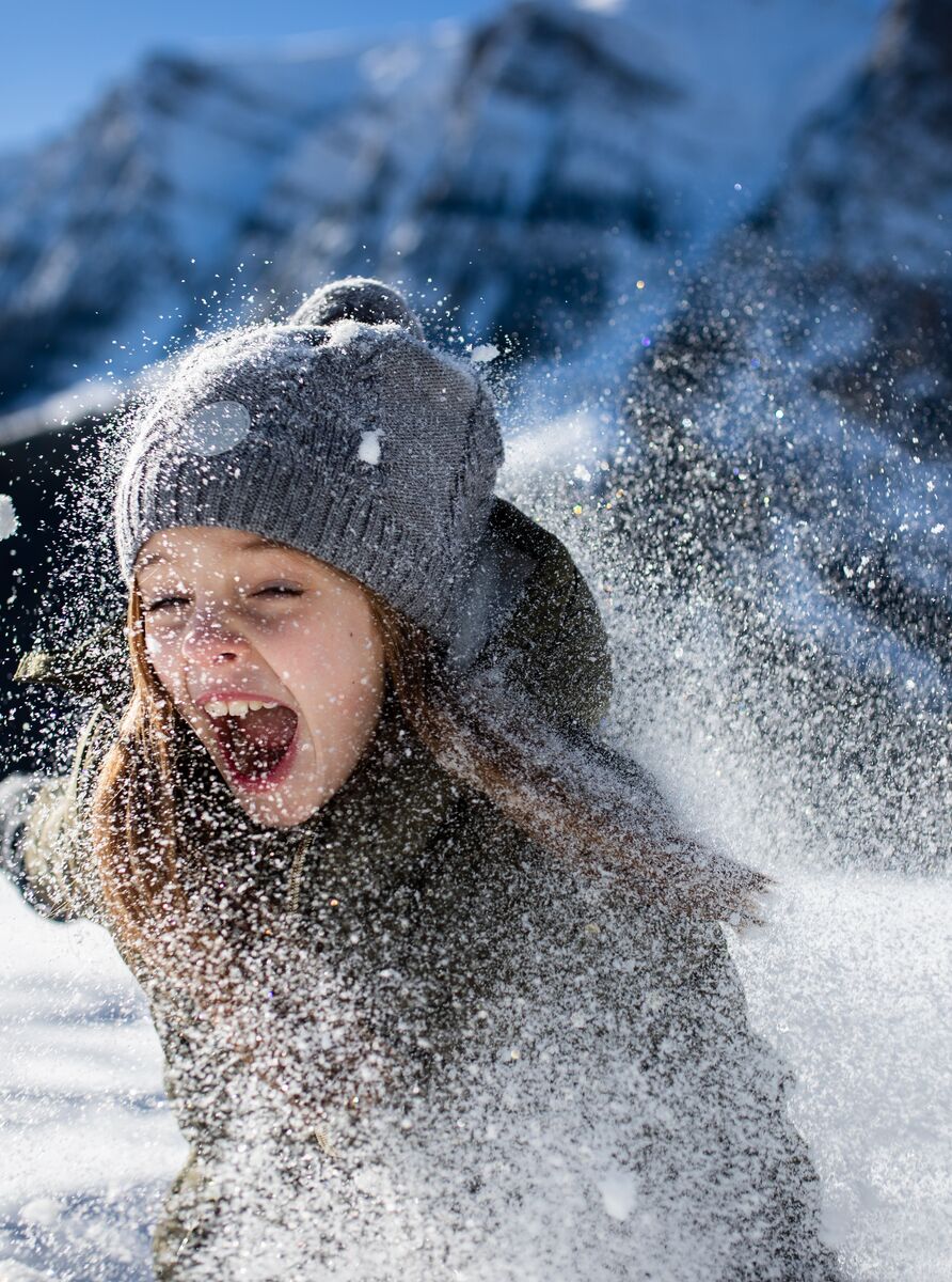 A family playing in the snow at Lake Louise in the winter
