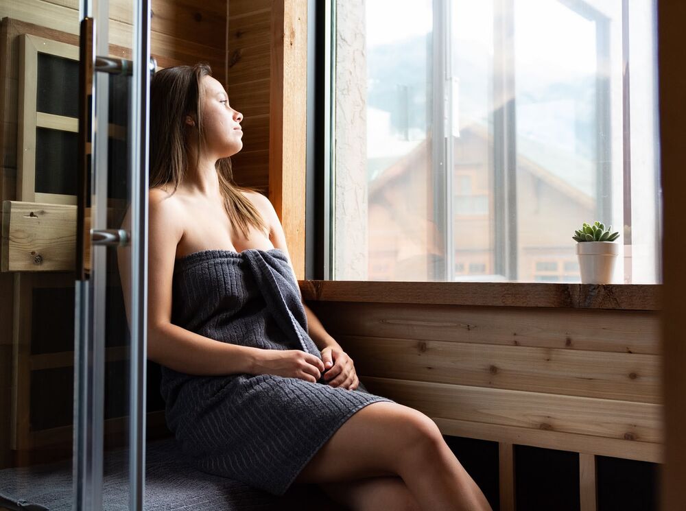A woman relaxes at Cedar & Sage Co. spa in Banff National Park