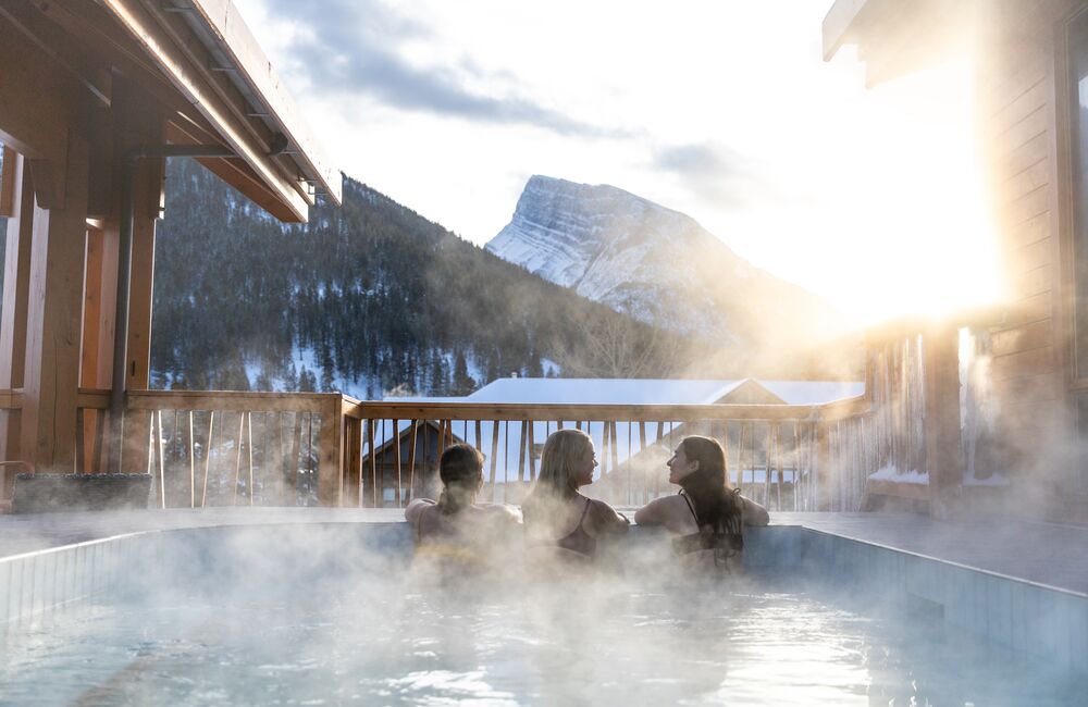 Outdoor Hot Tub on a balcony with winter mountains in the background