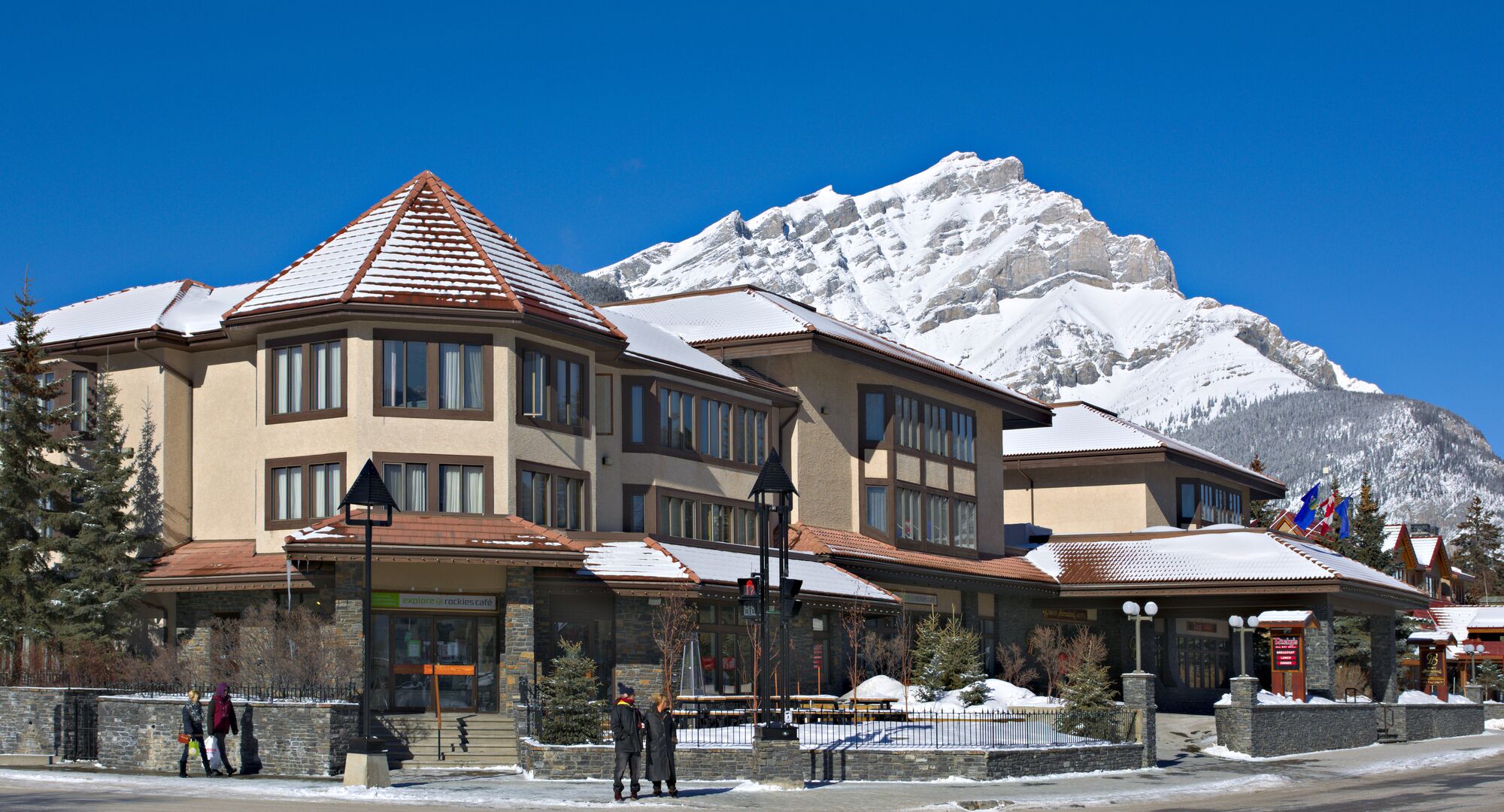 The exterior of the Elk & Avenue Hotel on a snowy day in Banff National Park