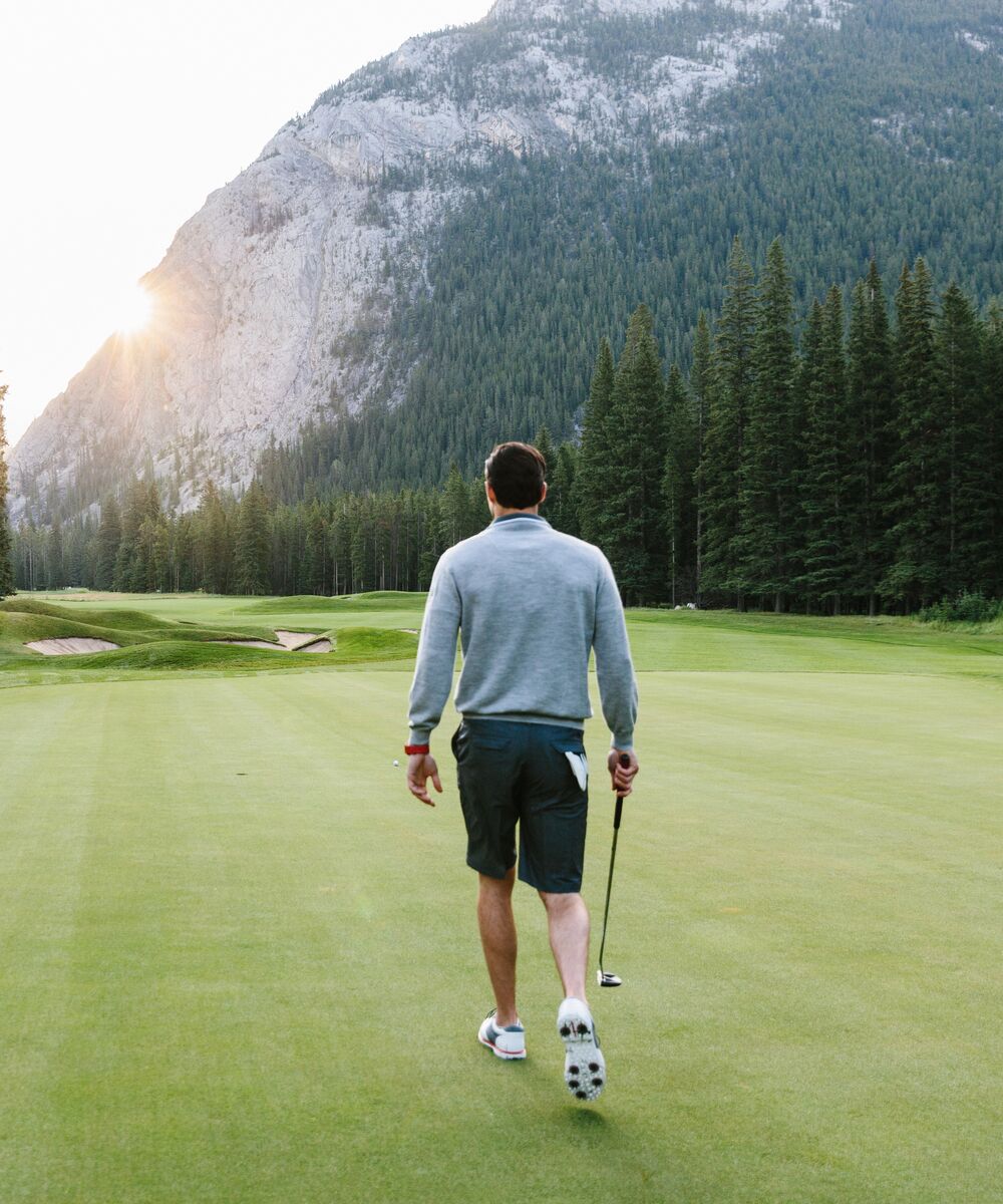 A person teeing off at the Fairmont Banff Springs Golf Course