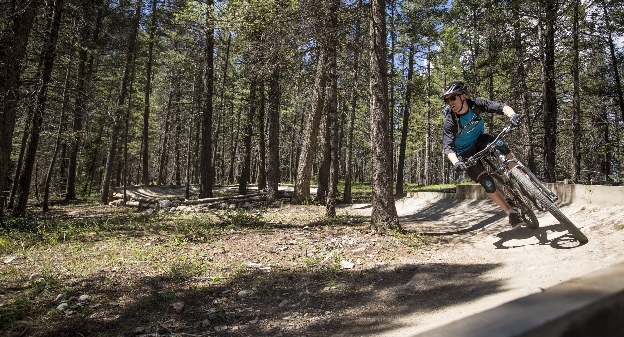 A person mountain biking one of the Tunnel Mountain trails