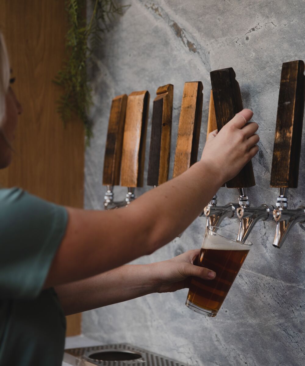 Staff member pouring beer at Three Bears Brewery & Restaurant