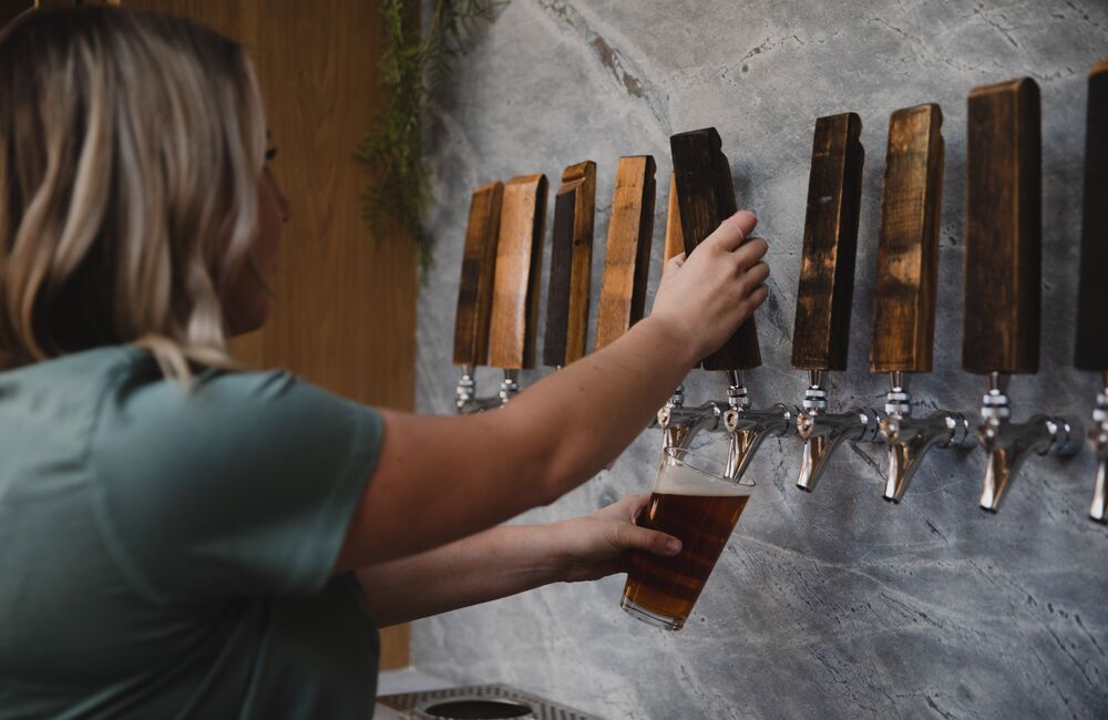 Staff member pouring beer at Three Bears Brewery & Restaurant