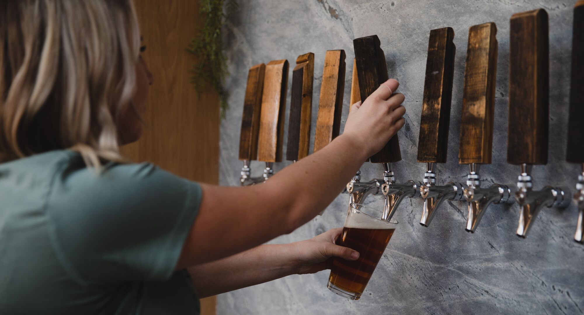 Staff member pouring beer at Three Bears Brewery & Restaurant
