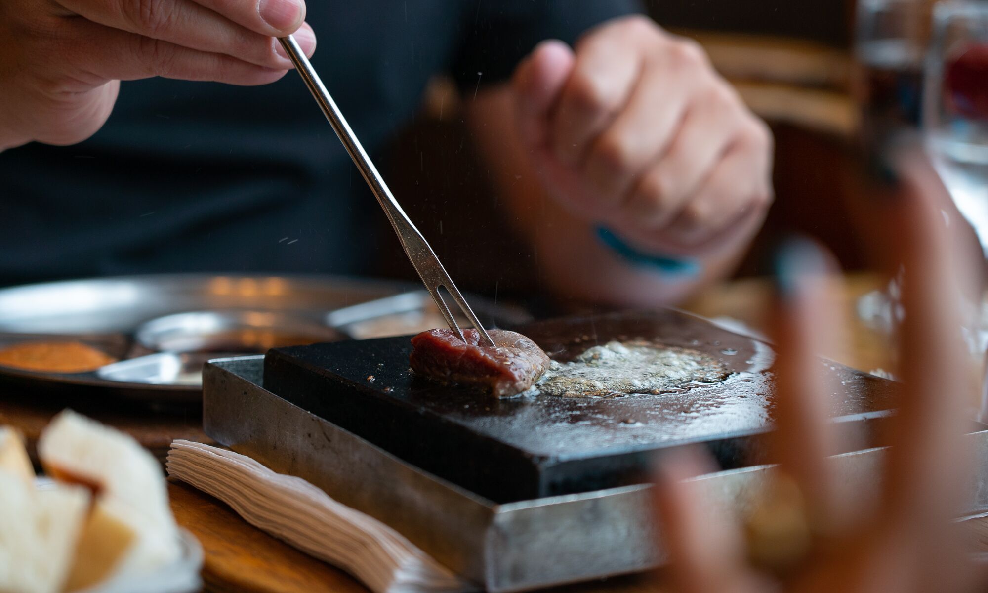 Meat cooking on a griddle for fondue in Banff.