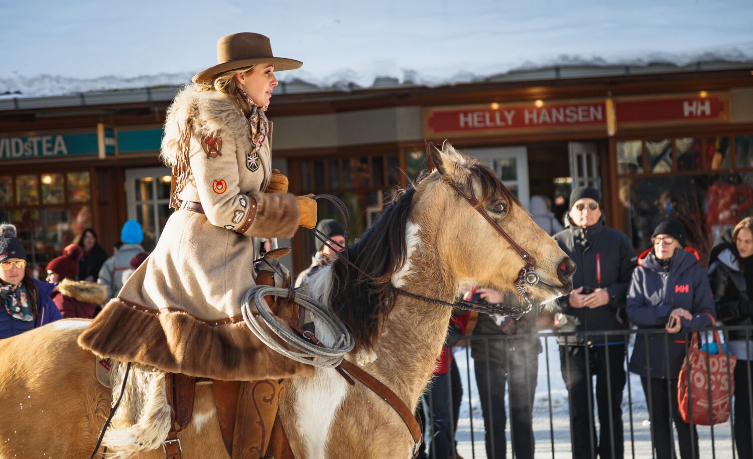 A rider on a horse moving down Banff Avenue during the Skijoring Event of SnowDays