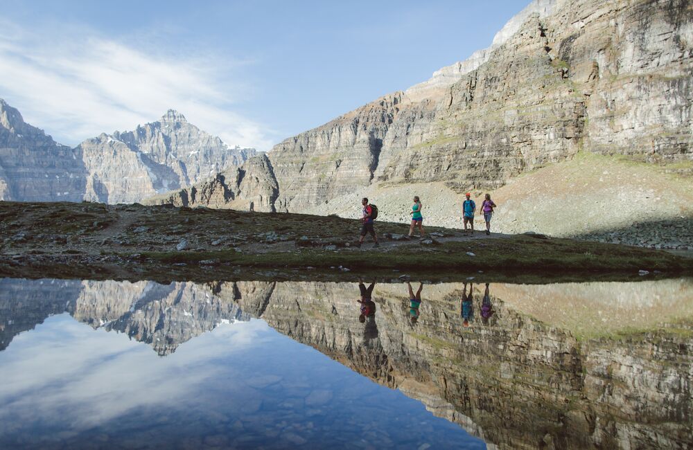 Friends hike Sentinel Pass at Moraine Lake on a summer day in Banff National Park