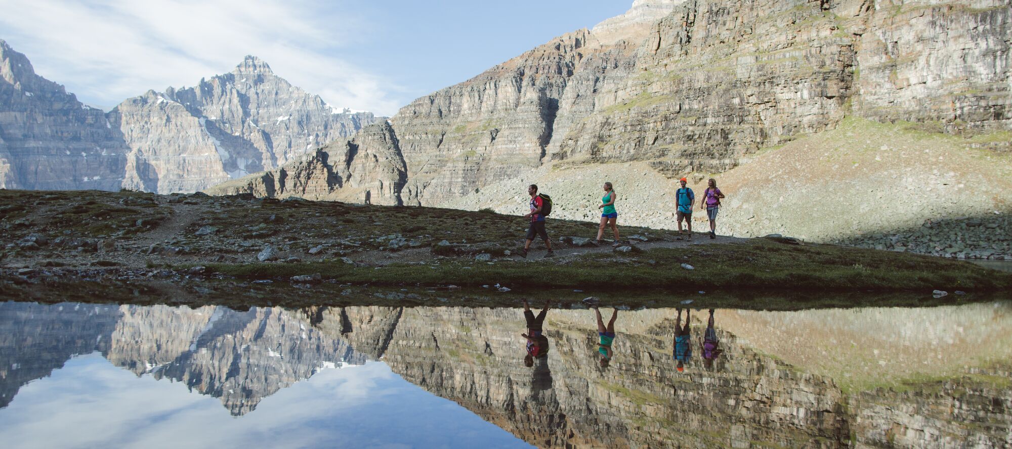 Friends hike Sentinel Pass at Moraine Lake on a summer day in Banff National Park
