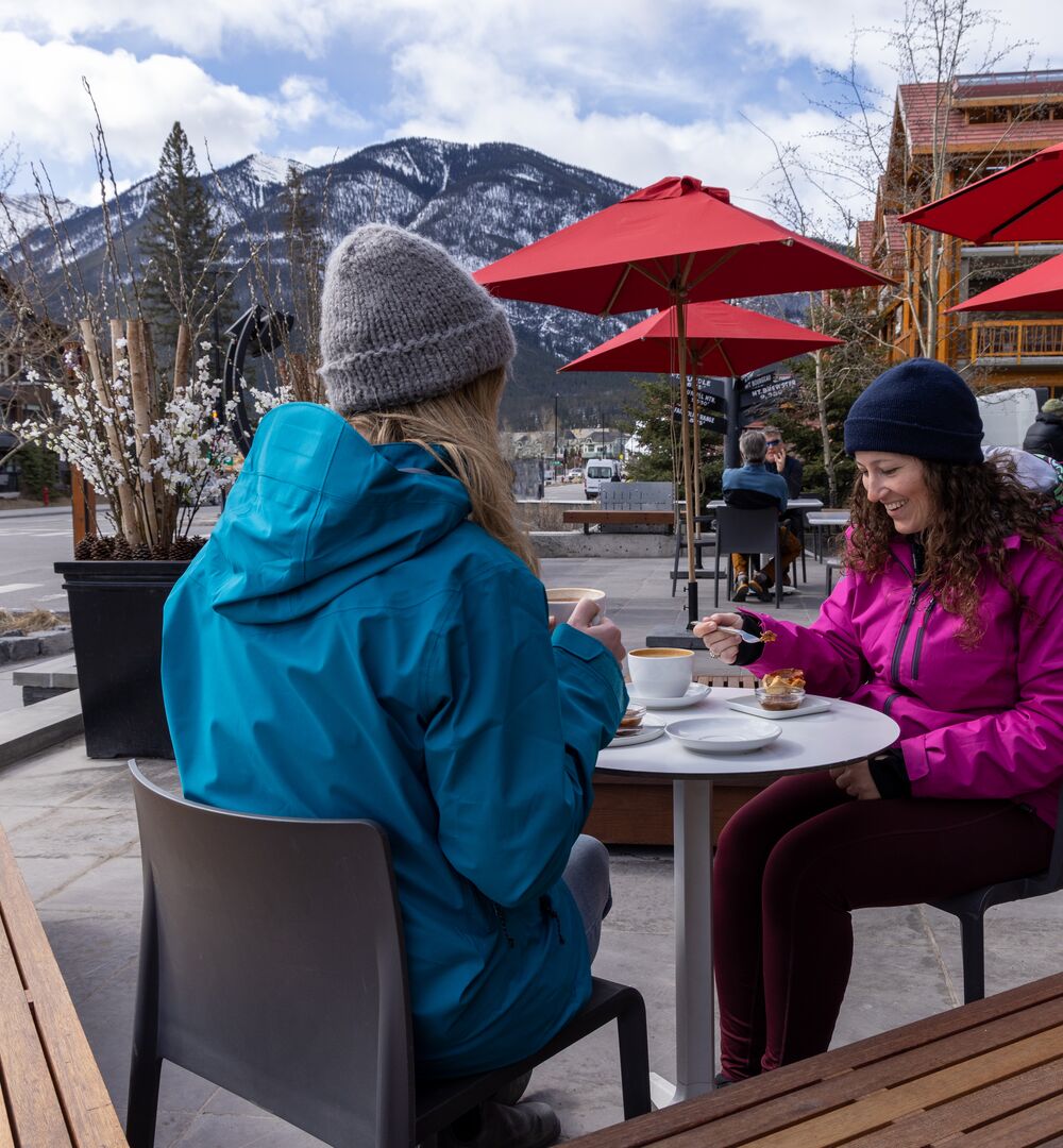 Three girls enjoying coffee at the Whitebark Cafe in Banff.