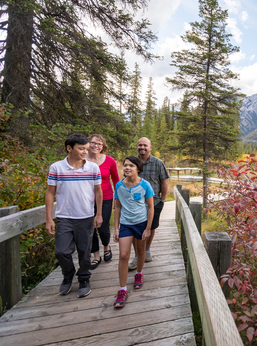 A family walks on the boardwalk at the Cave and Basin in Banff National Park.