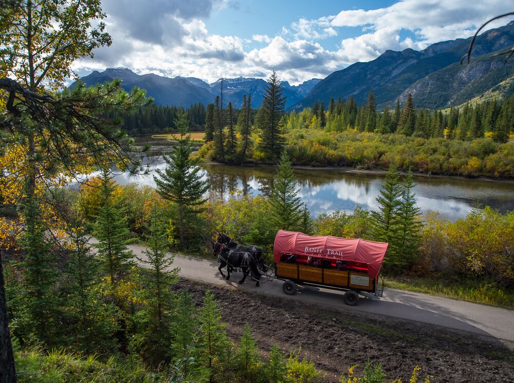 A horse drawn wagon following a trail along the river