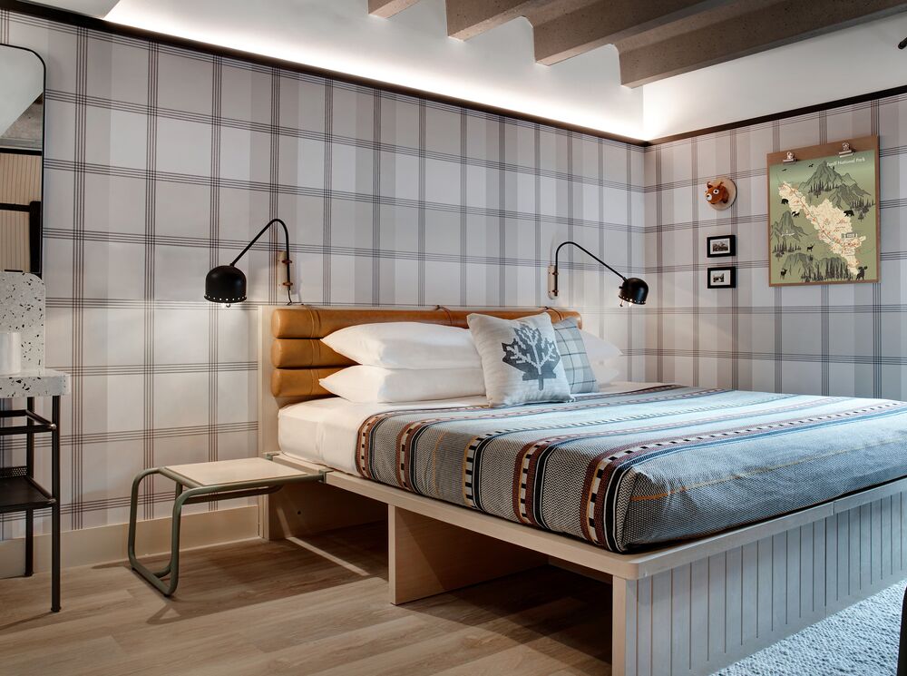 Interior of a room with a king bed at the Moxy Banff.