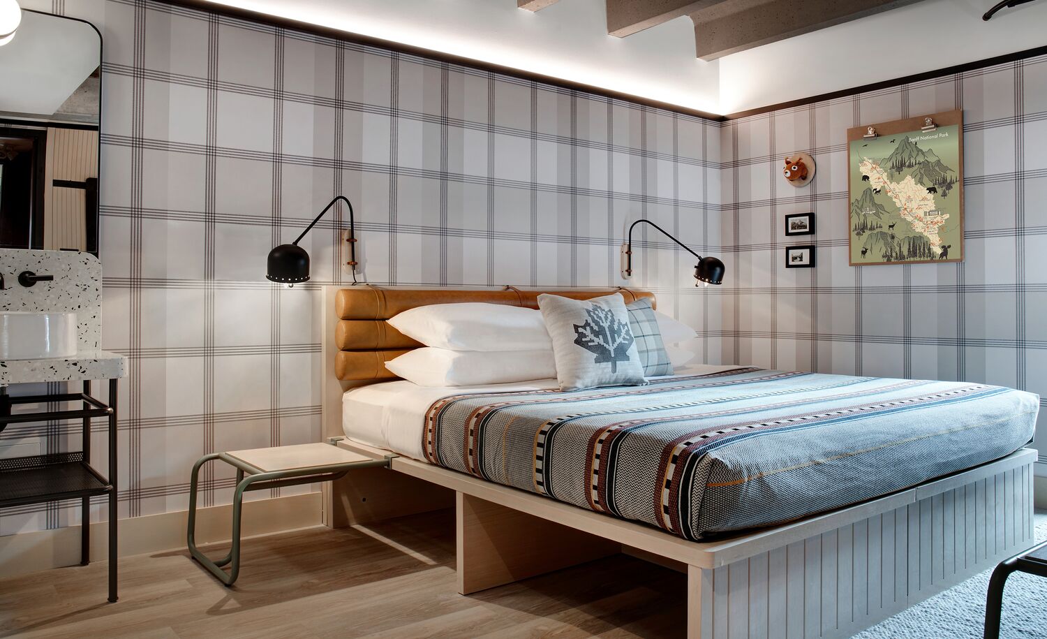 Interior of a room with a king bed at the Moxy Banff.