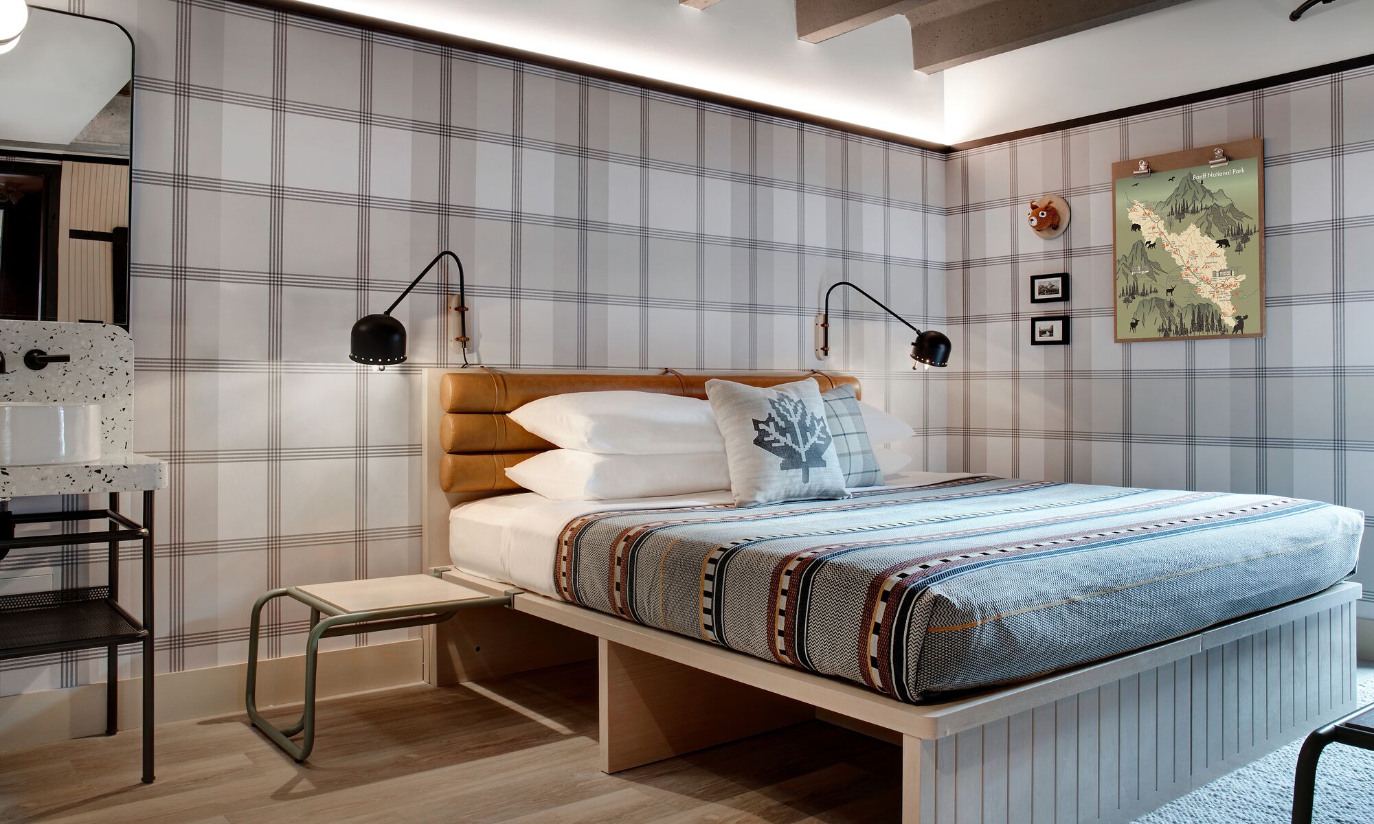 Interior of a room with a king bed at the Moxy Banff.