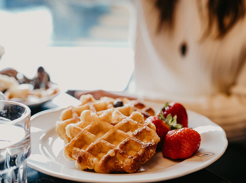 Waffles sit on a plate with strawberries at a table at the Vermilion Room at the Banff Springs Hotel in Banff.