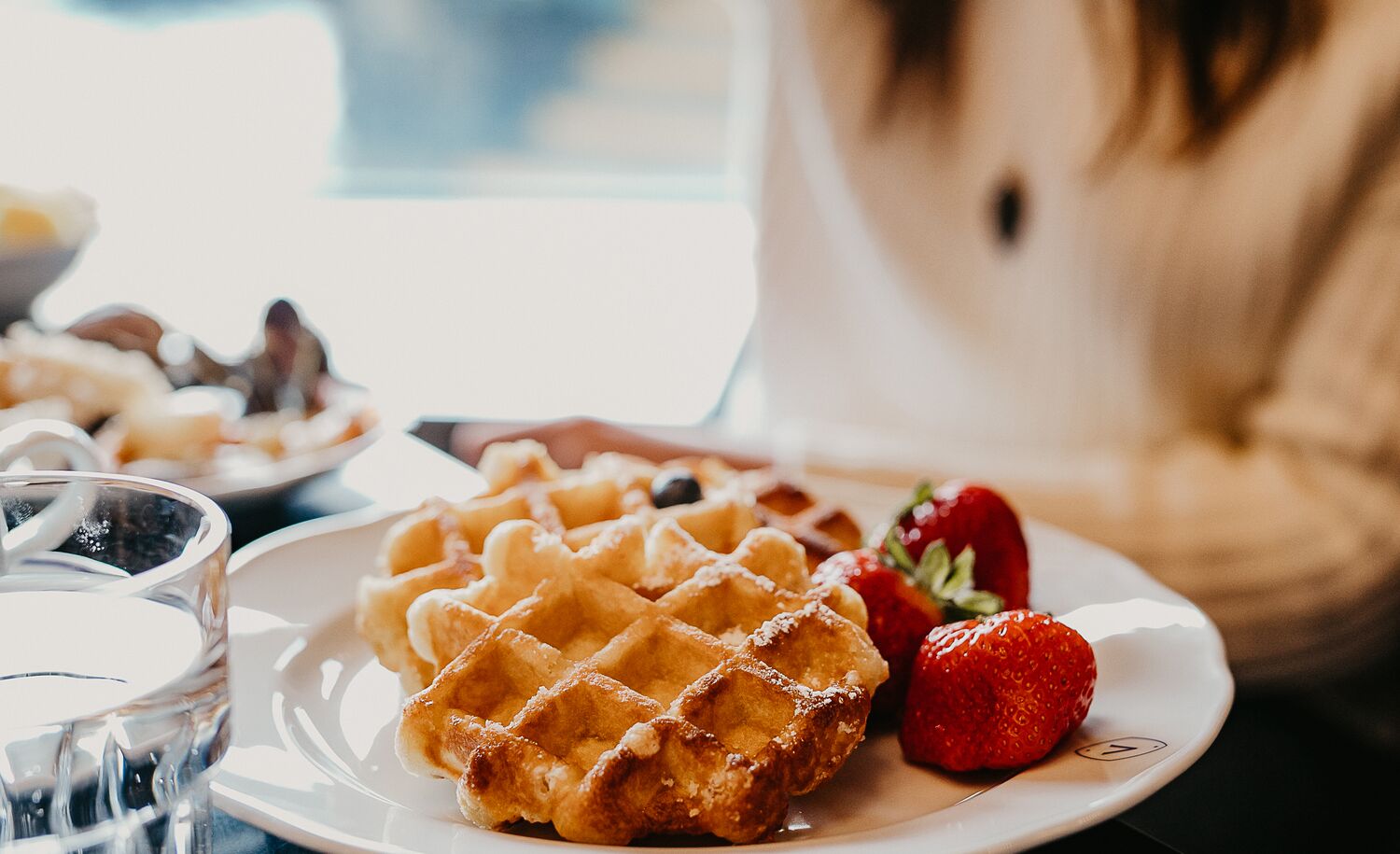 Waffles sit on a plate with strawberries at a table at the Vermilion Room at the Banff Springs Hotel in Banff.