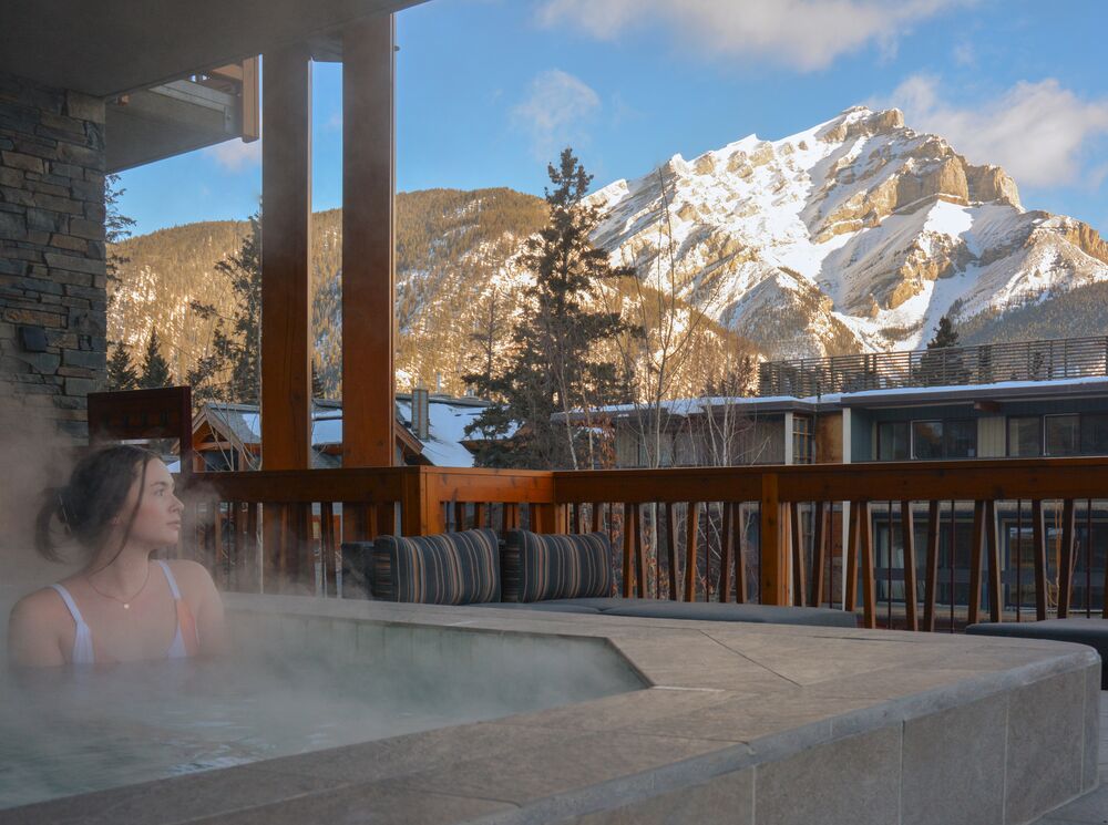 A woman sits in a hot tub at the Meadows Spa in Banff National Park.