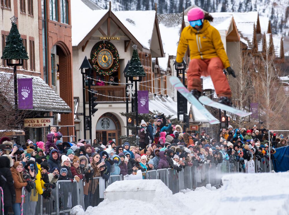 A skier flys over a jump while the crowd watches behind them at Skijoring in Banff as part of the Snow Days festival.