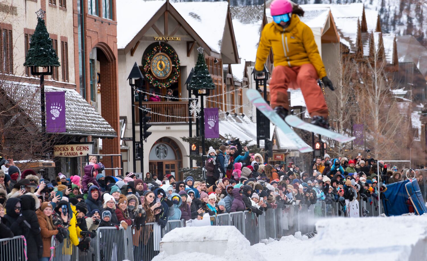 A skier flys over a jump while the crowd watches behind them at Skijoring in Banff as part of the Snow Days festival.