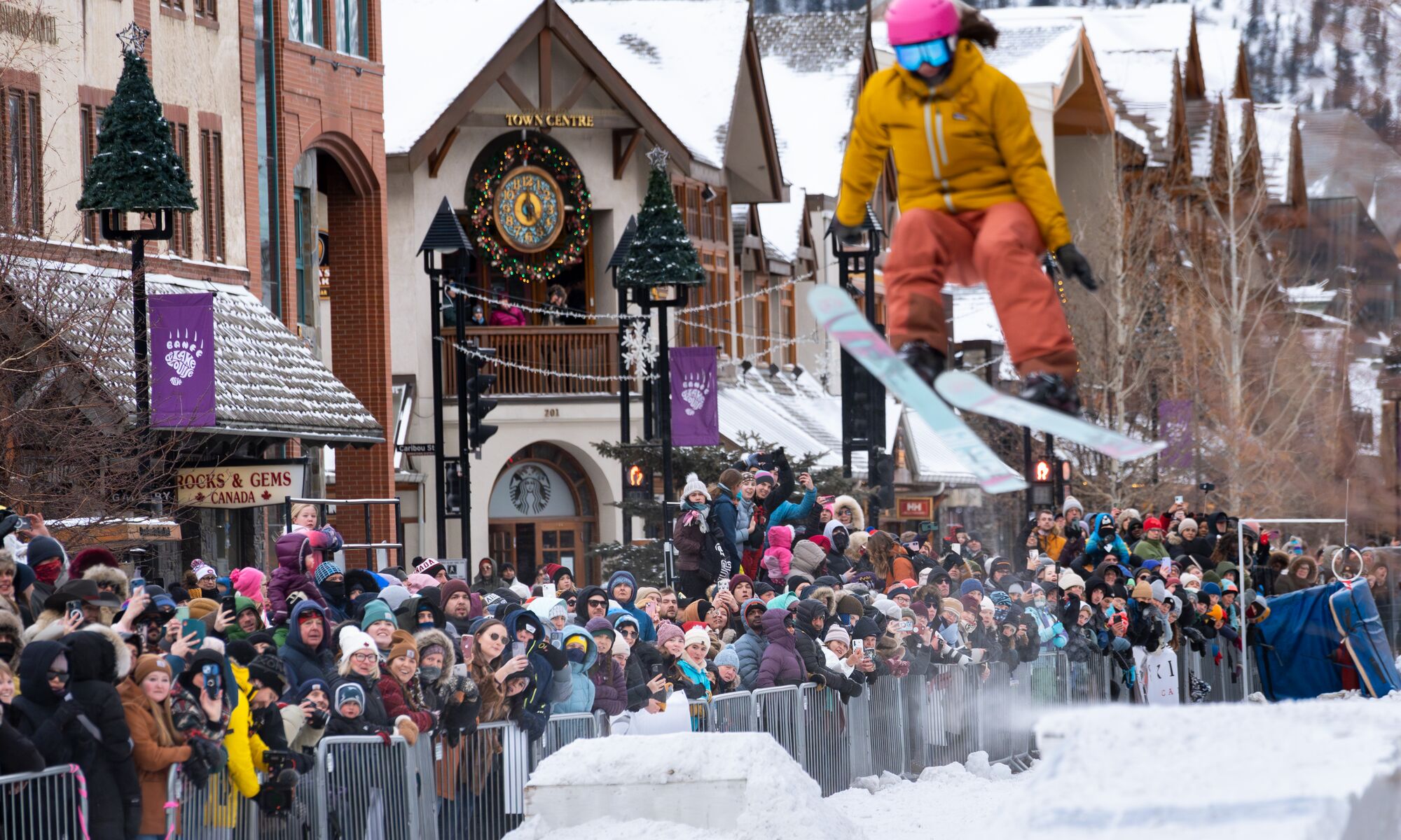 A skier flys over a jump while the crowd watches behind them at Skijoring in Banff as part of the Snow Days festival.