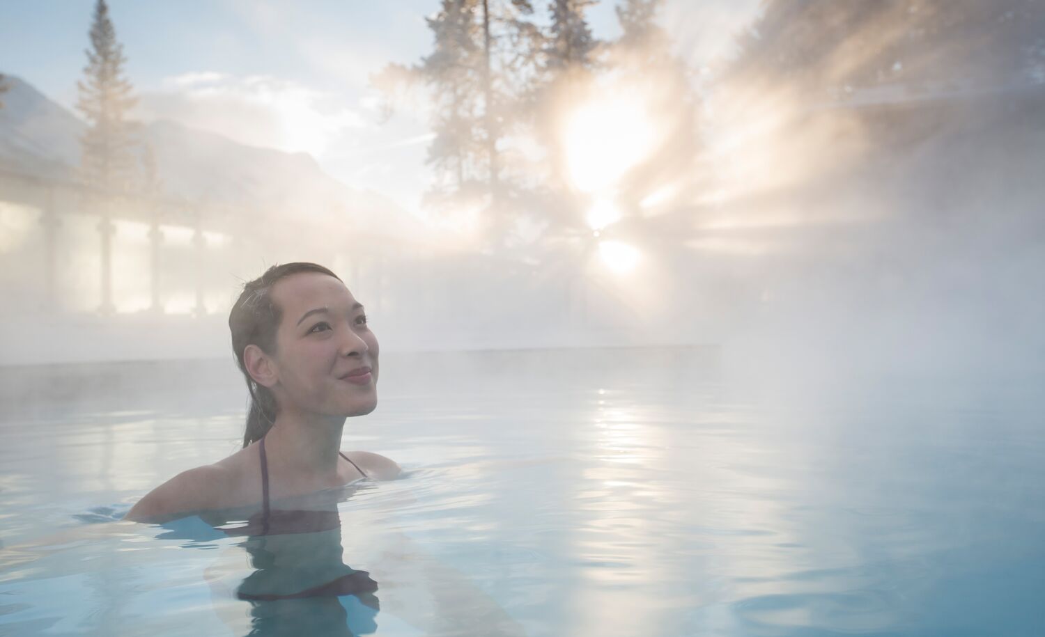 A woman swims in the Banff Upper Hot Springs in the winter.
