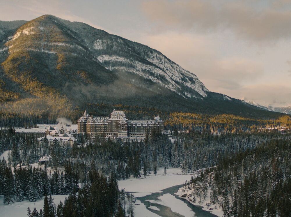 The Fairmont Banff Springs Hotel seen from a distance with a mountain in the background in Banff.