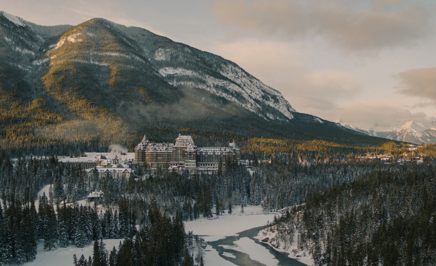 The Fairmont Banff Springs Hotel seen from a distance with a mountain in the background in Banff.