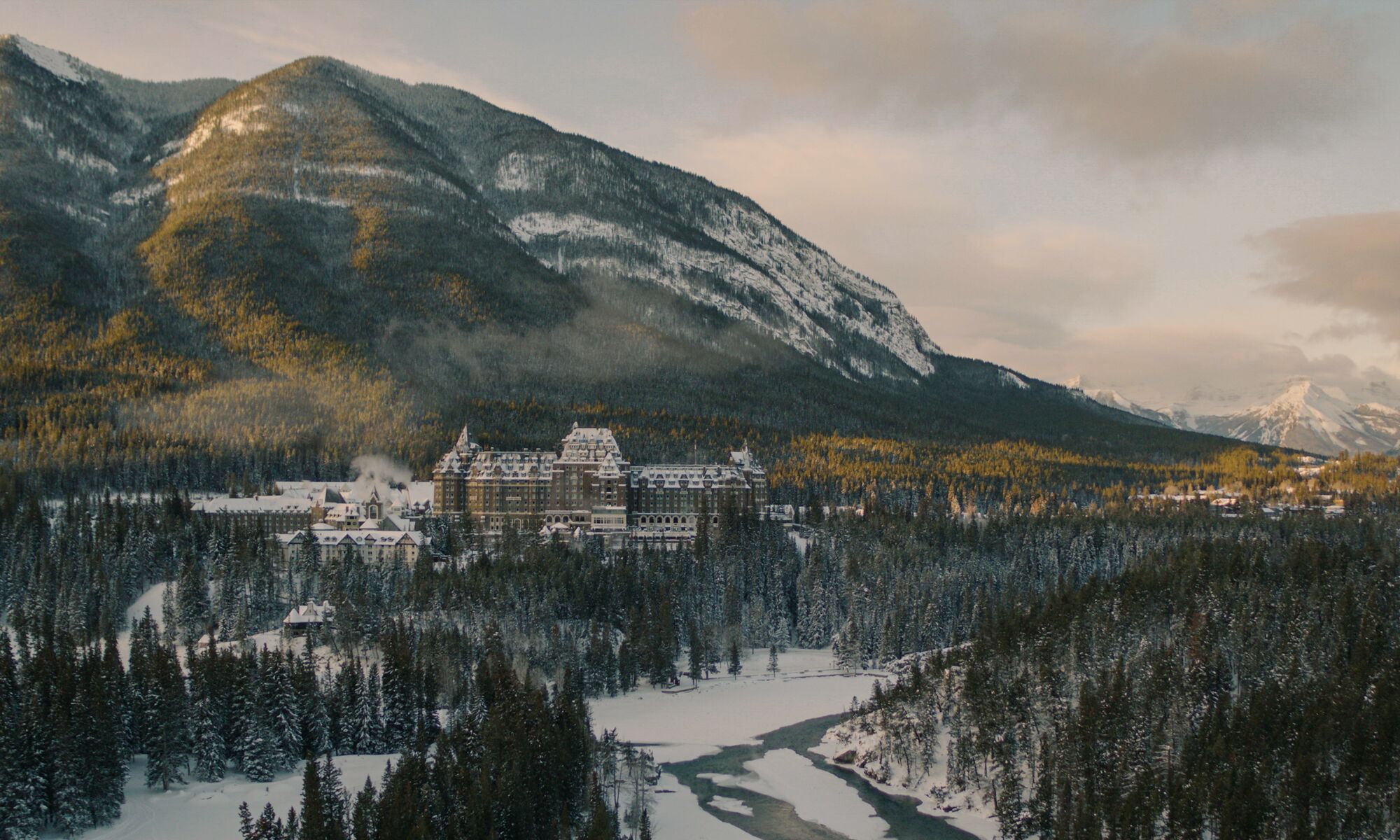 The Fairmont Banff Springs Hotel seen from a distance with a mountain in the background in Banff.