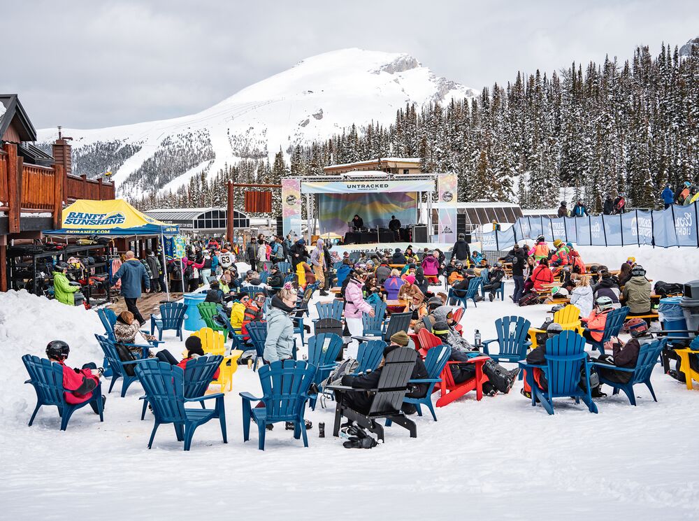 People listening to a live band at the Mad Trappers Beer Garden at Banff Sunshine Village