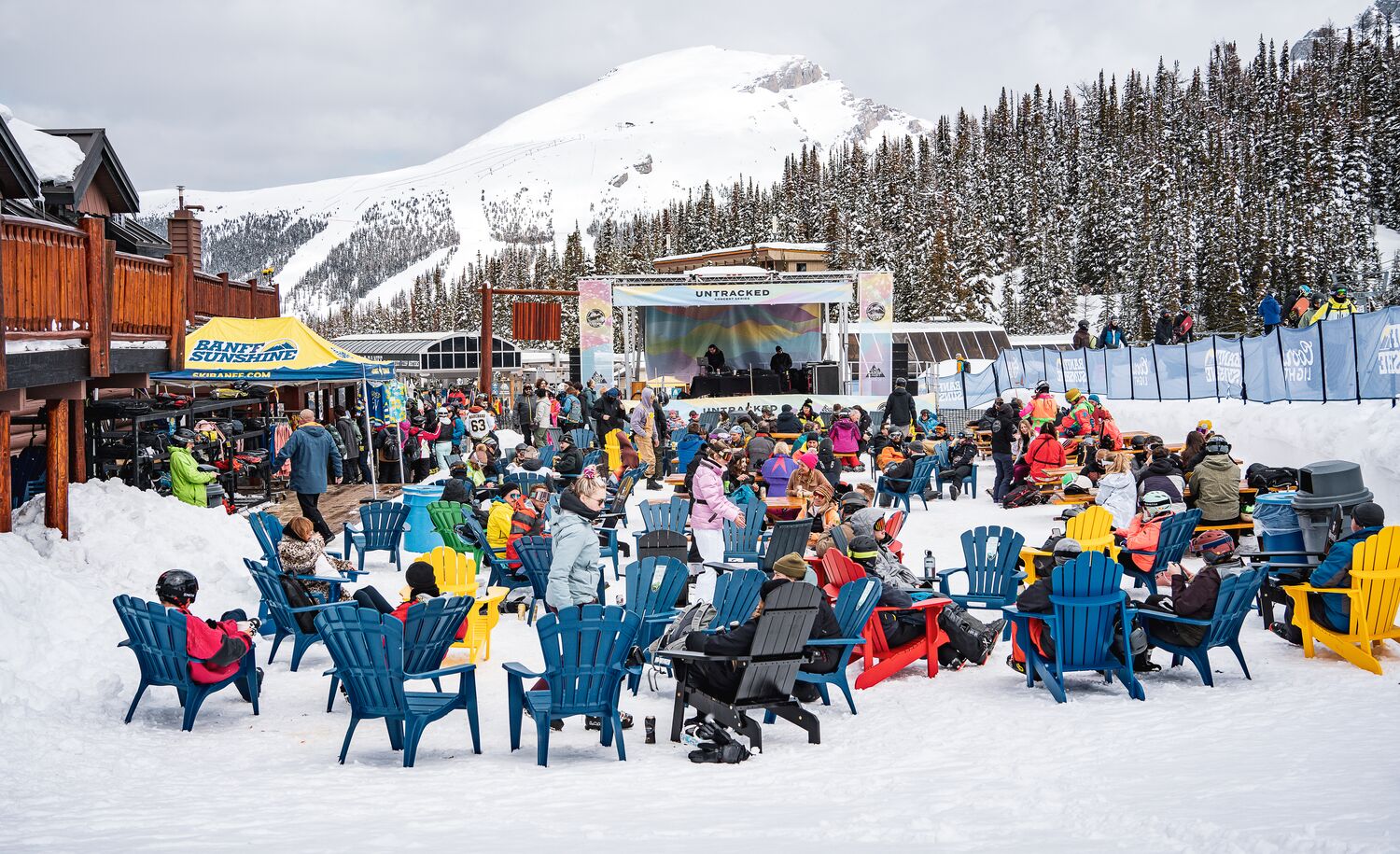 People listening to a live band at the Mad Trappers Beer Garden at Banff Sunshine Village