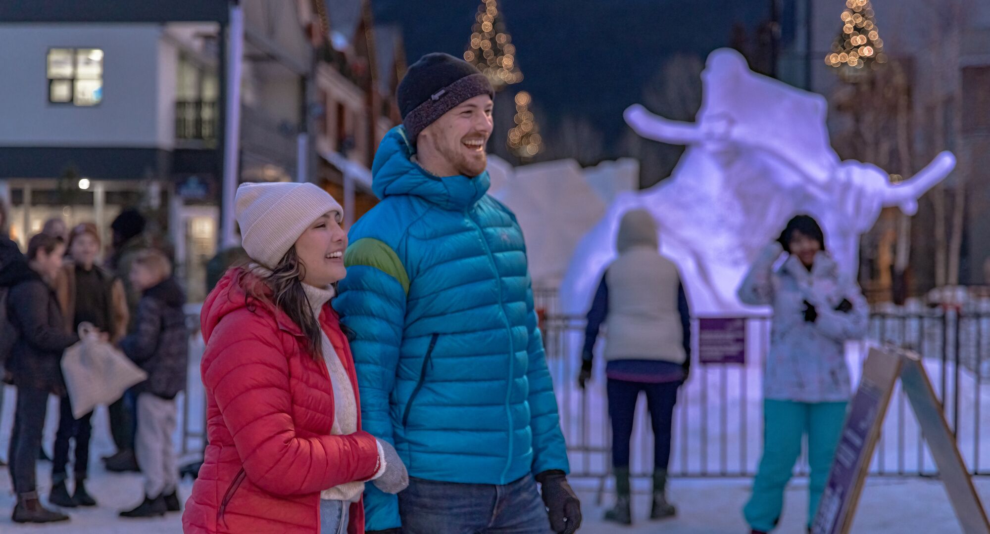 A couple exploring Bear Street in the evening during SnowDays