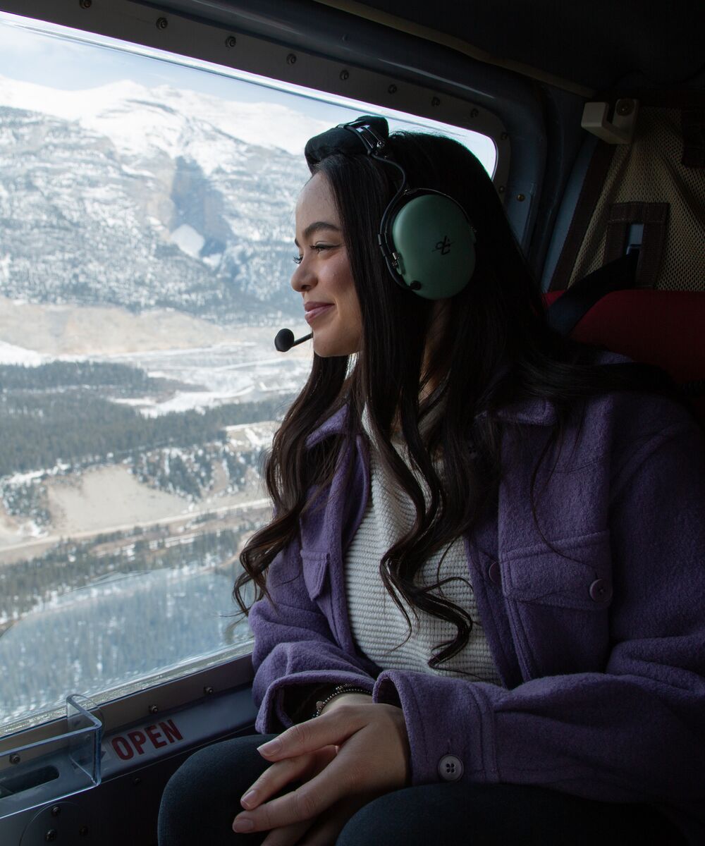 A person on a helicopter tour over the Canadian Rockies