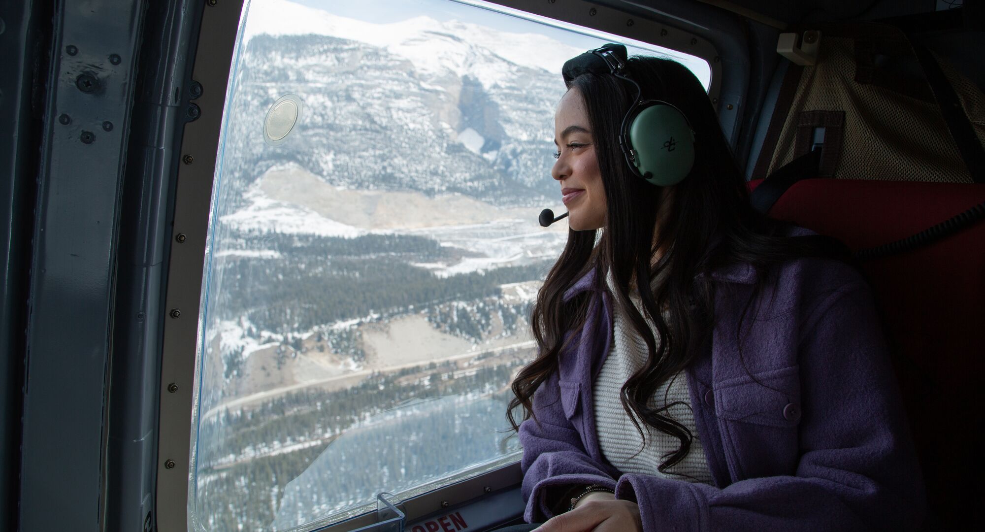 A person on a helicopter ride over the Canadian Rockies