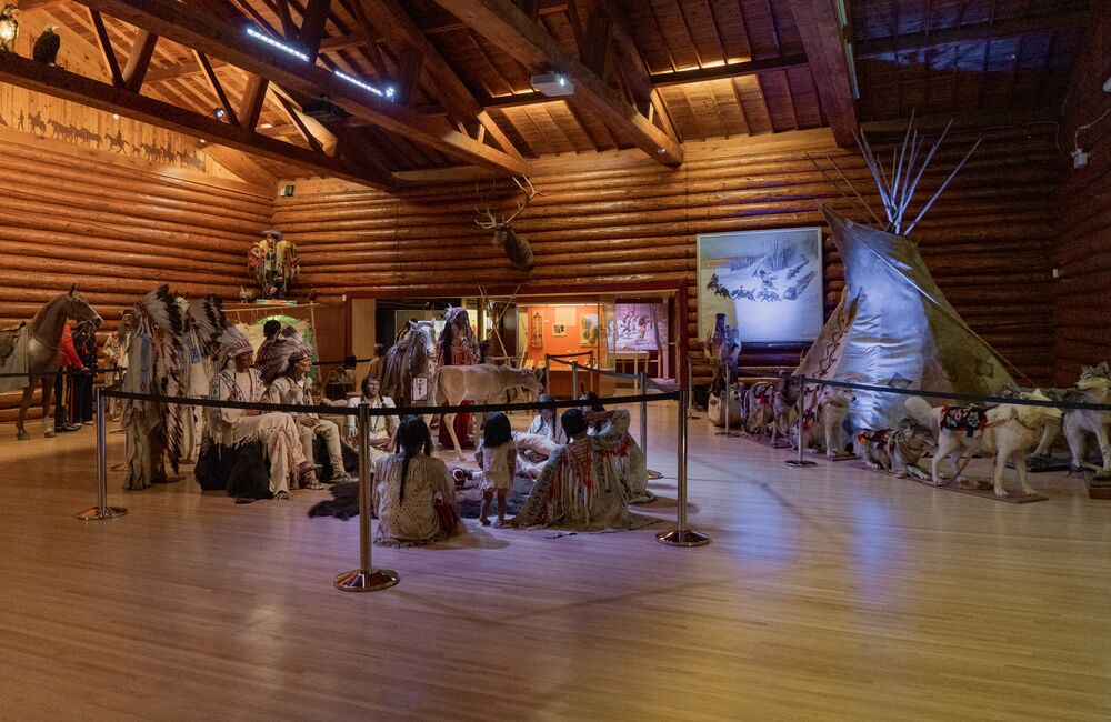 An interior of the displays at the Buffalo Nations Museum in Banff showing traditional clothing and a teepee. 