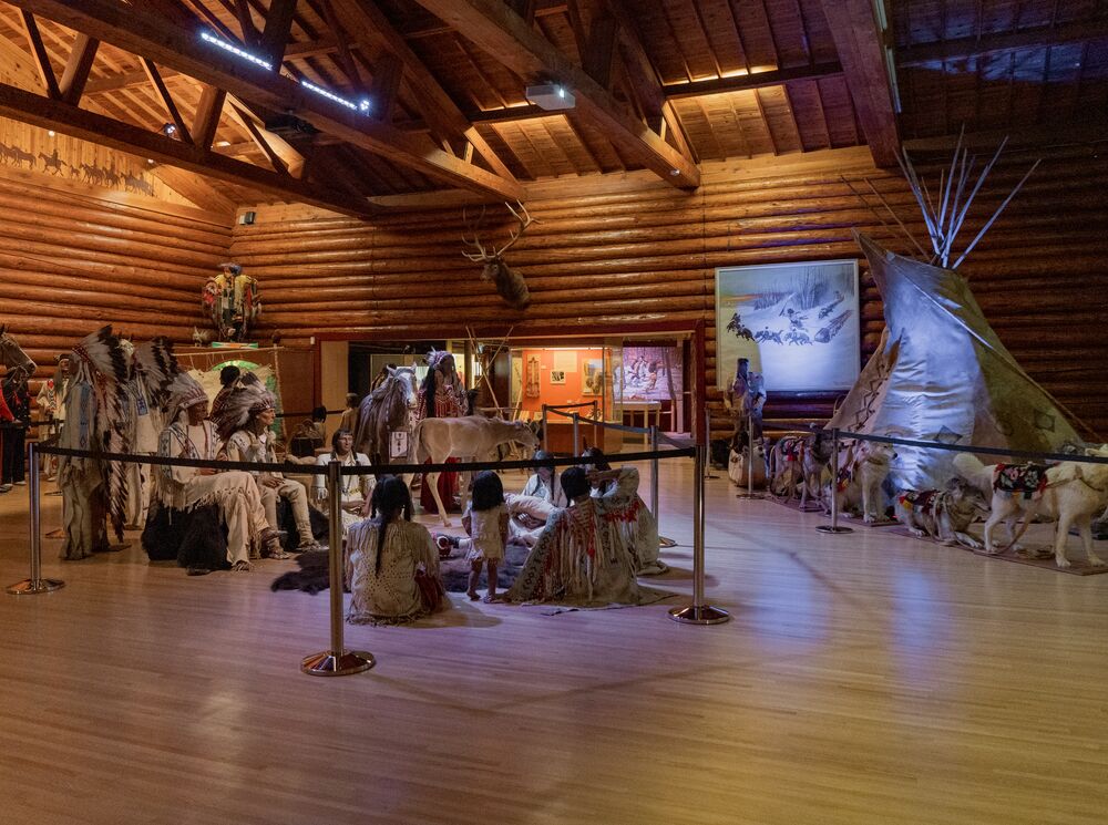 An interior of the displays at the Buffalo Nations Museum in Banff showing traditional clothing and a teepee. 